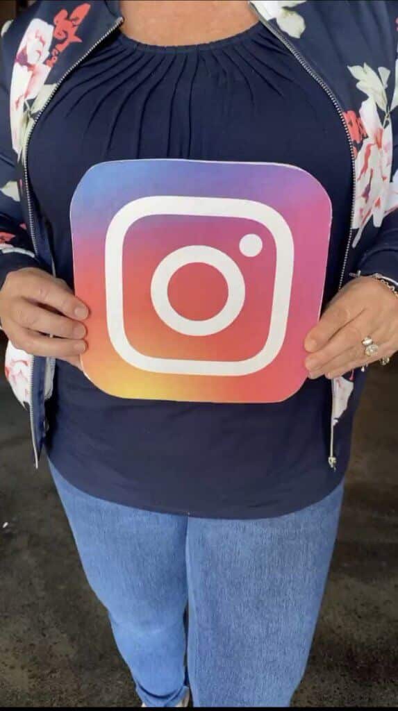 holding instagram sign